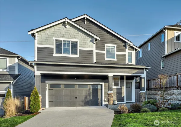 a front view of a house with a yard and garage