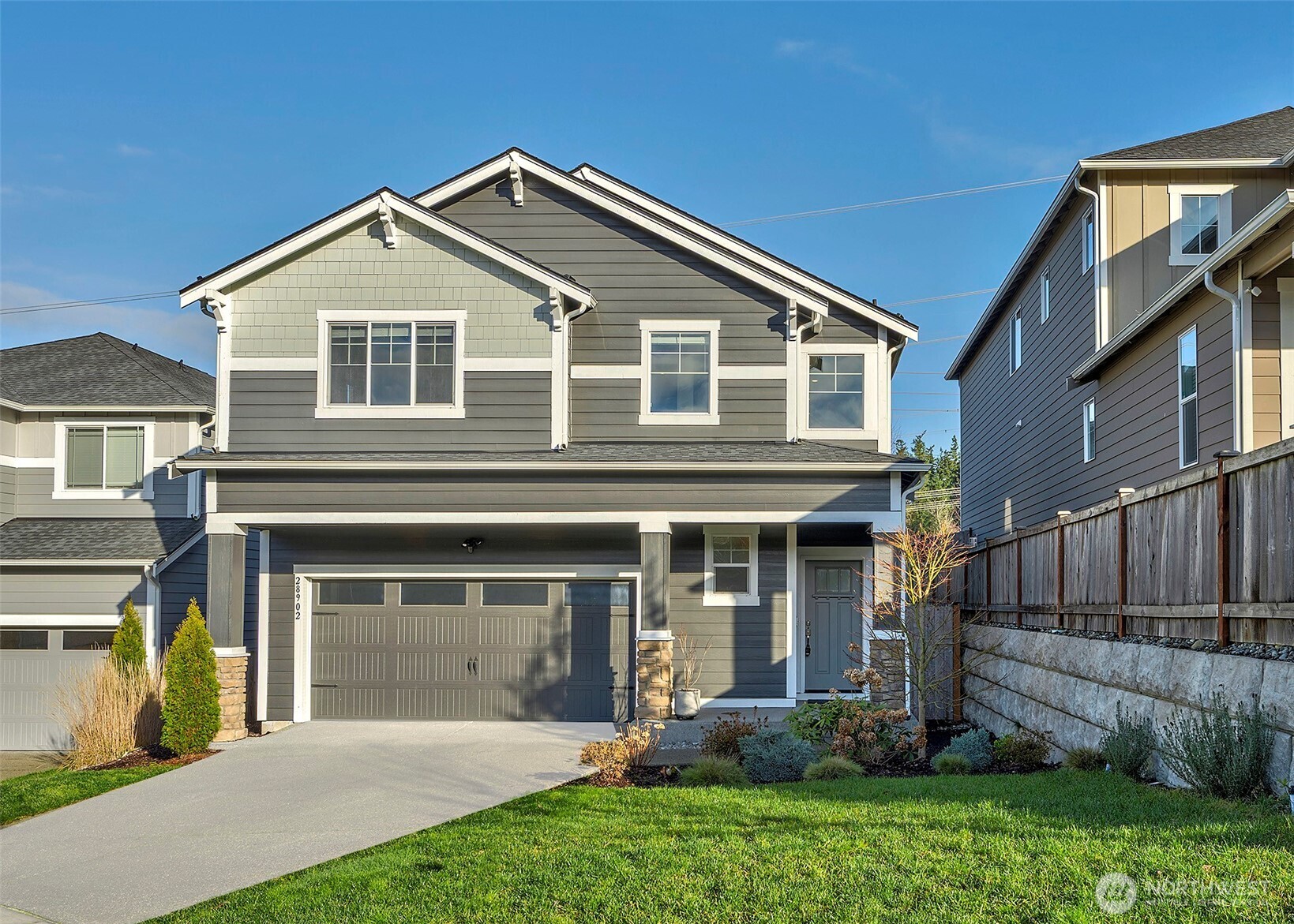 28902 239th Avenue Southeast Maple Valley, WA 98010 - Photo 2 of 36 a front view of a house with a yard