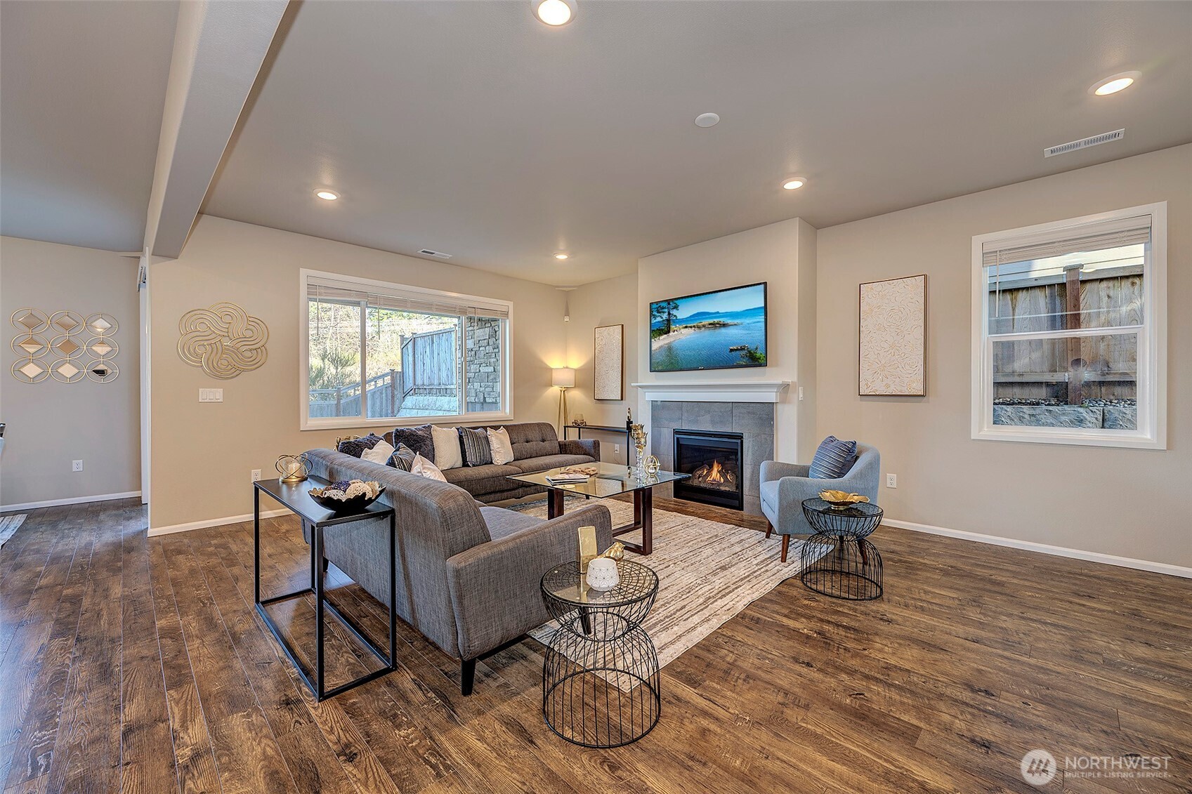 28902 239th Avenue Southeast Maple Valley, WA 98010 - Photo 7 of 36 a living room with furniture a fireplace and a flat screen tv