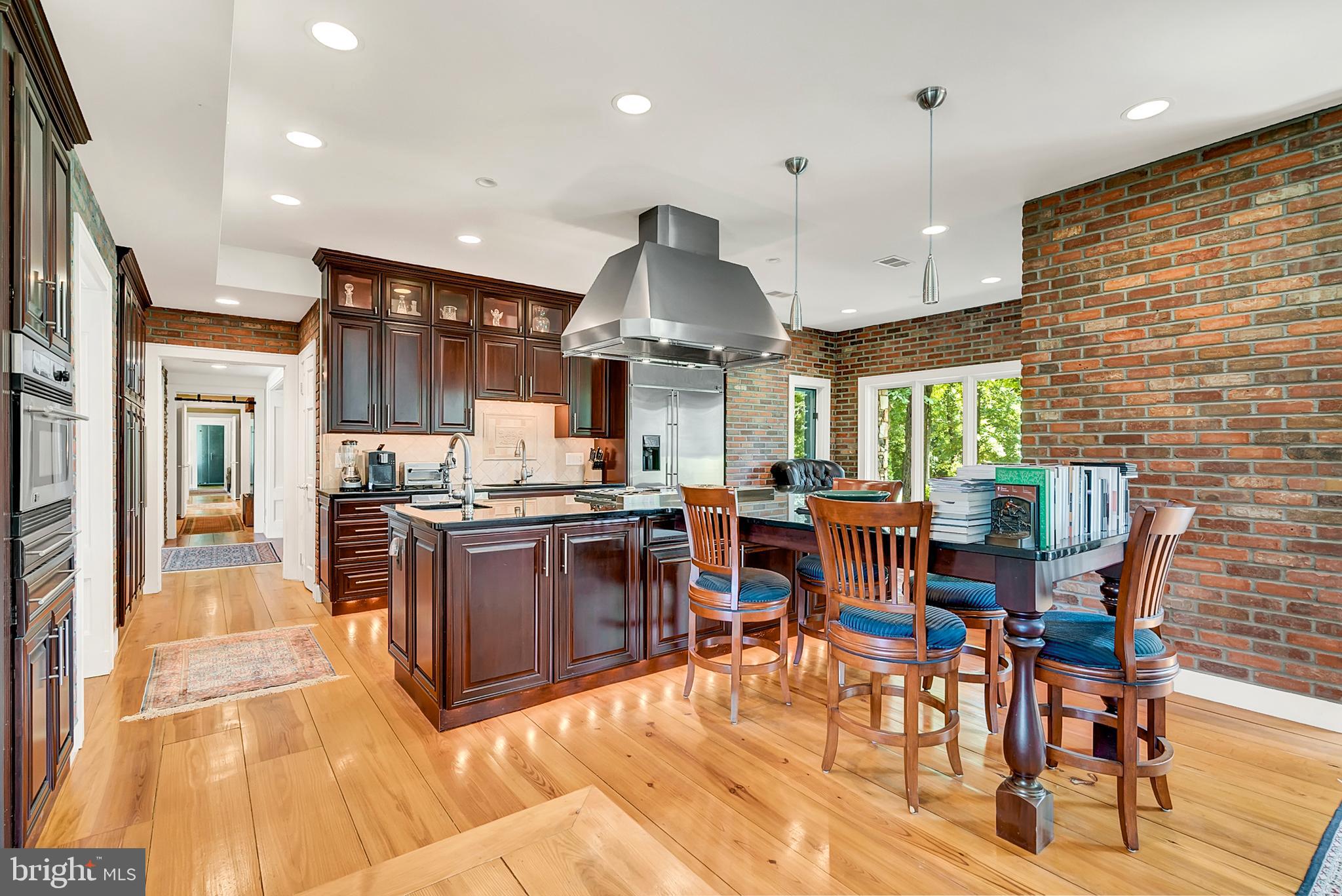 20022 Trappe Road Bluemont, VA 20135 - Photo 27 of 97 a kitchen with stainless steel appliances granite countertop a stove oven a dining table and chairs with wooden floor