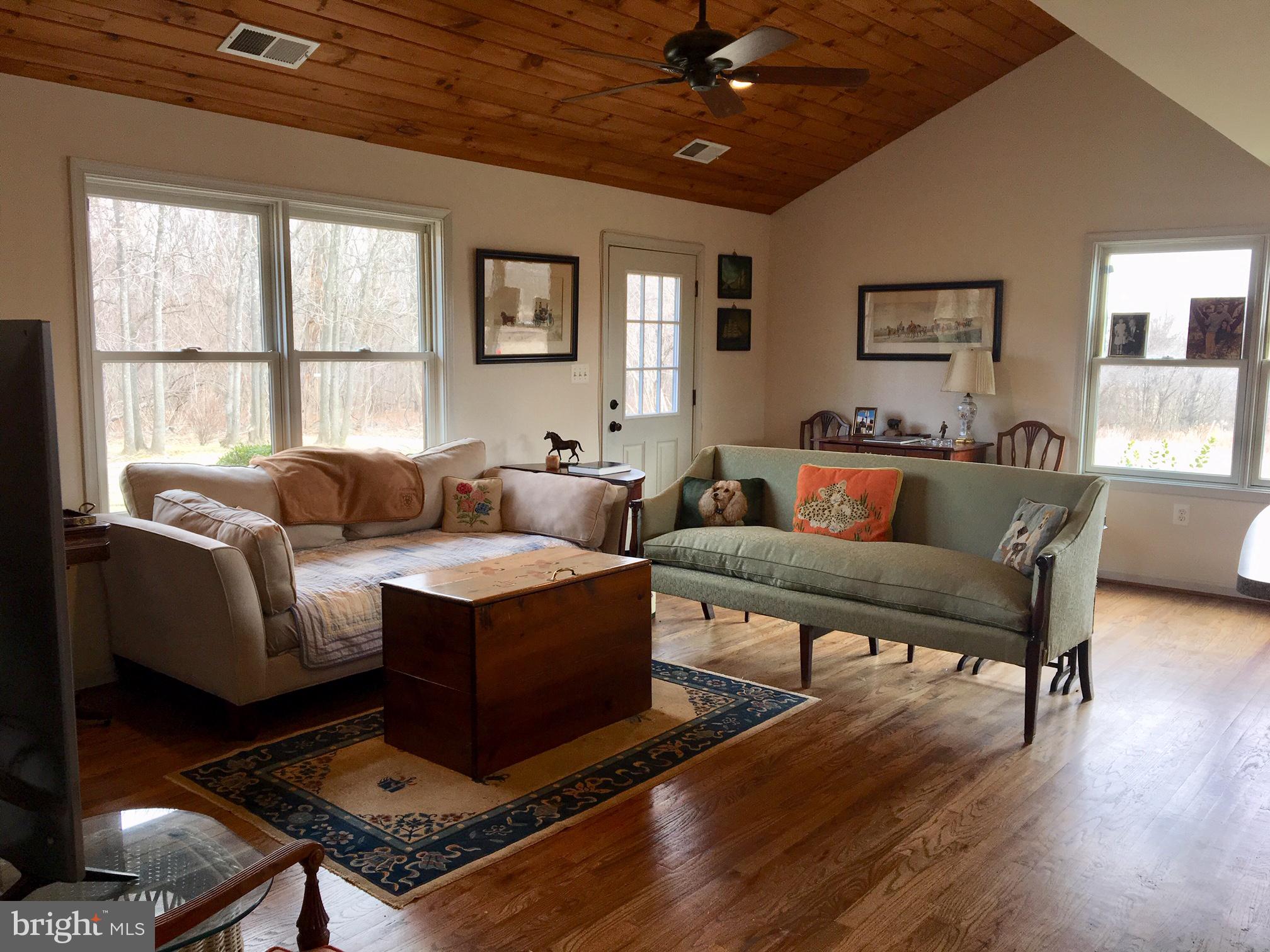 20022 Trappe Road Bluemont, VA 20135 - Photo 74 of 97 a living room with furniture a flat screen tv and a large window