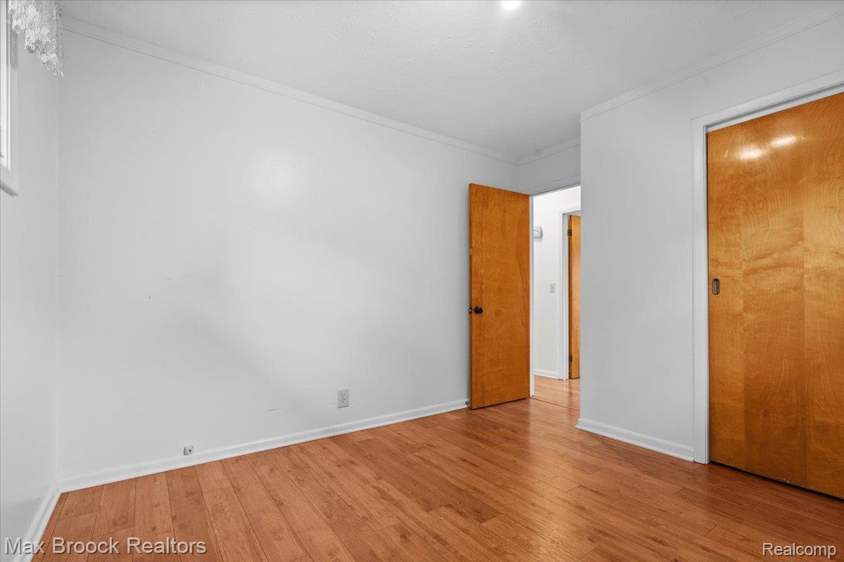 1330 Oak Street Rochester, MI 48307 - Photo 15 of 35 Hardwood flooring throughout, white walls, and bright overhead lighting