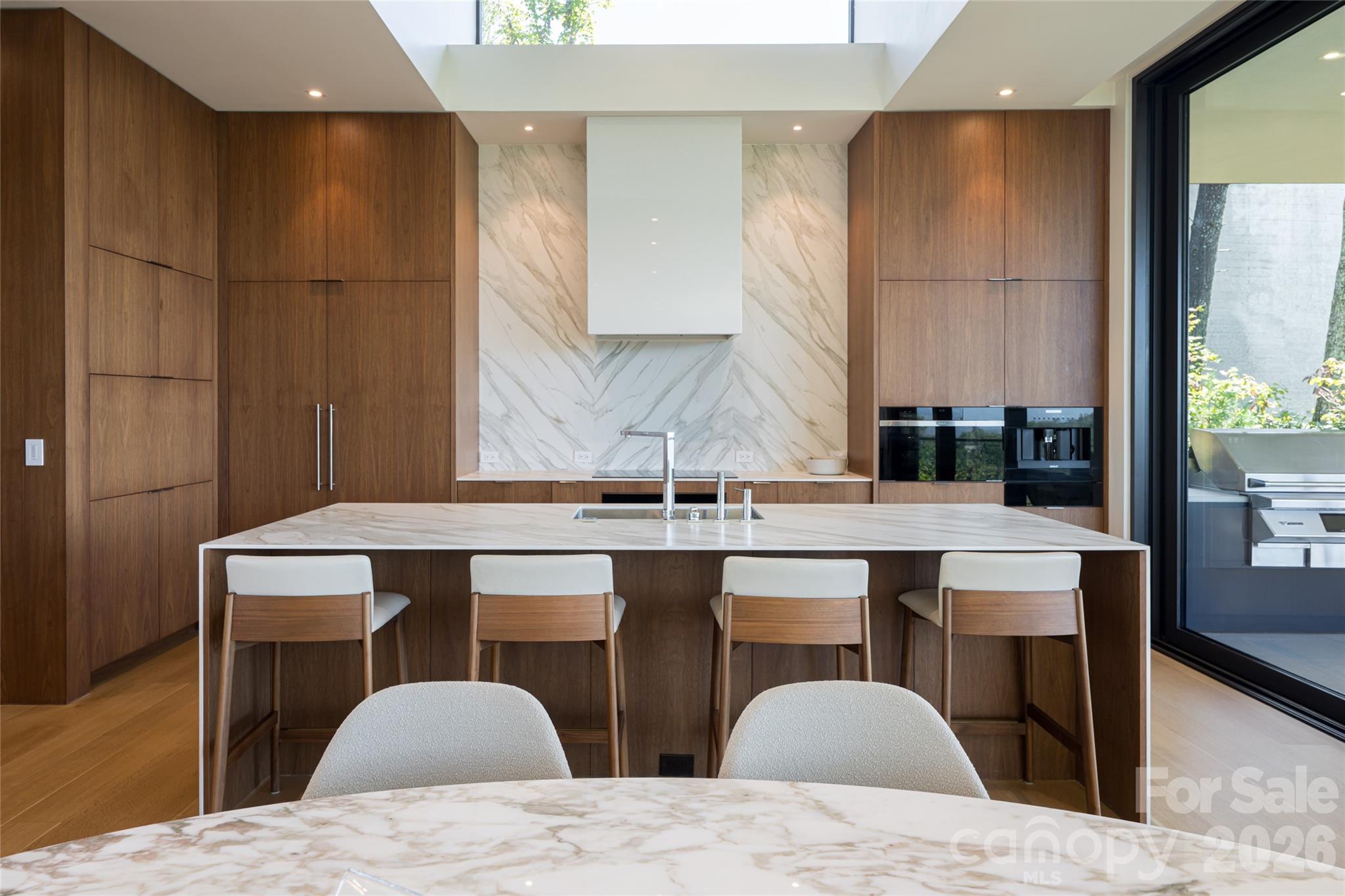 353 Retreat Ridge Way Asheville, NC 28804 - Photo 14 of 48 a kitchen with a table chairs sink and cabinets