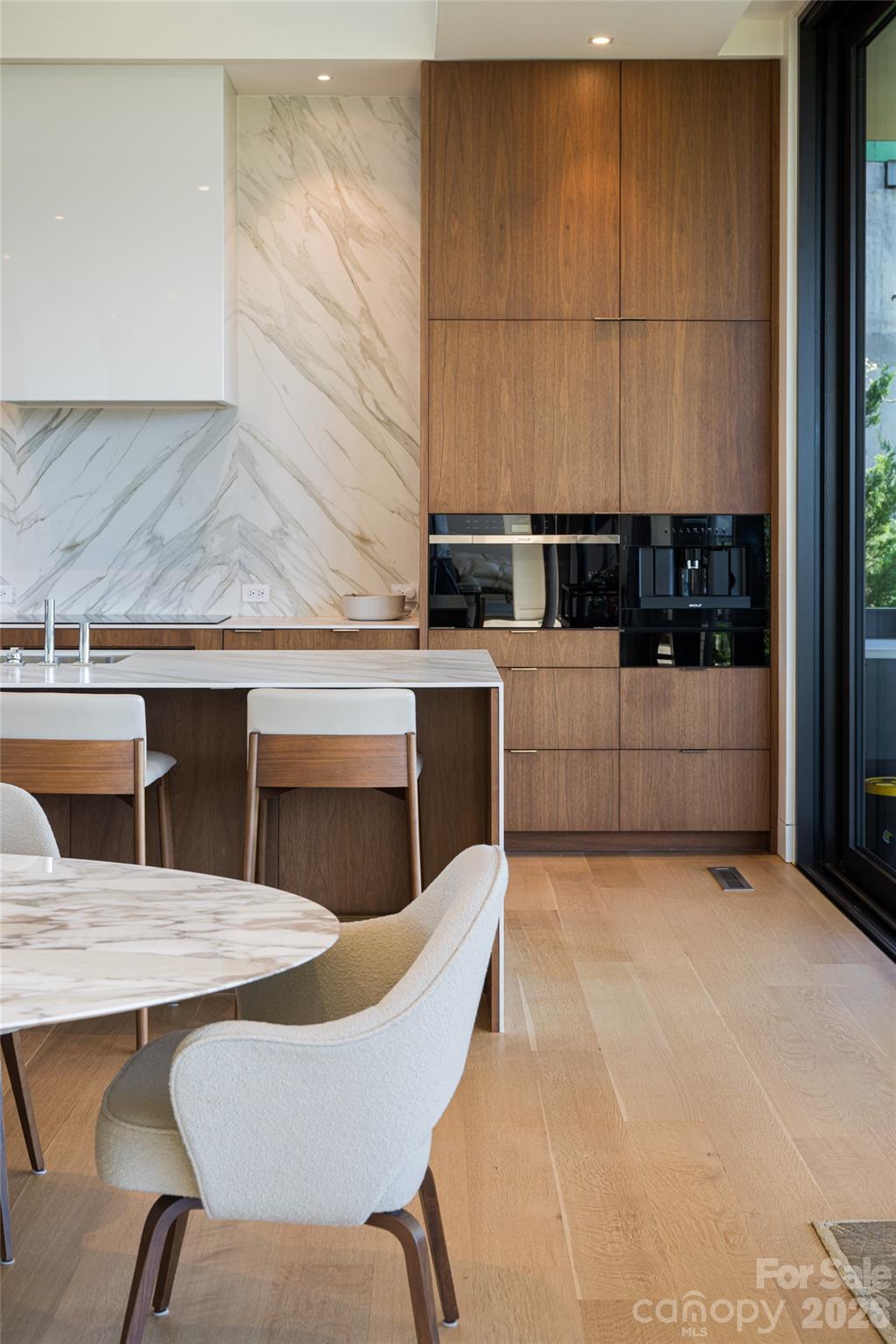 353 Retreat Ridge Way Asheville, NC 28804 - Photo 16 of 48 a kitchen with a table chairs sink and cabinets