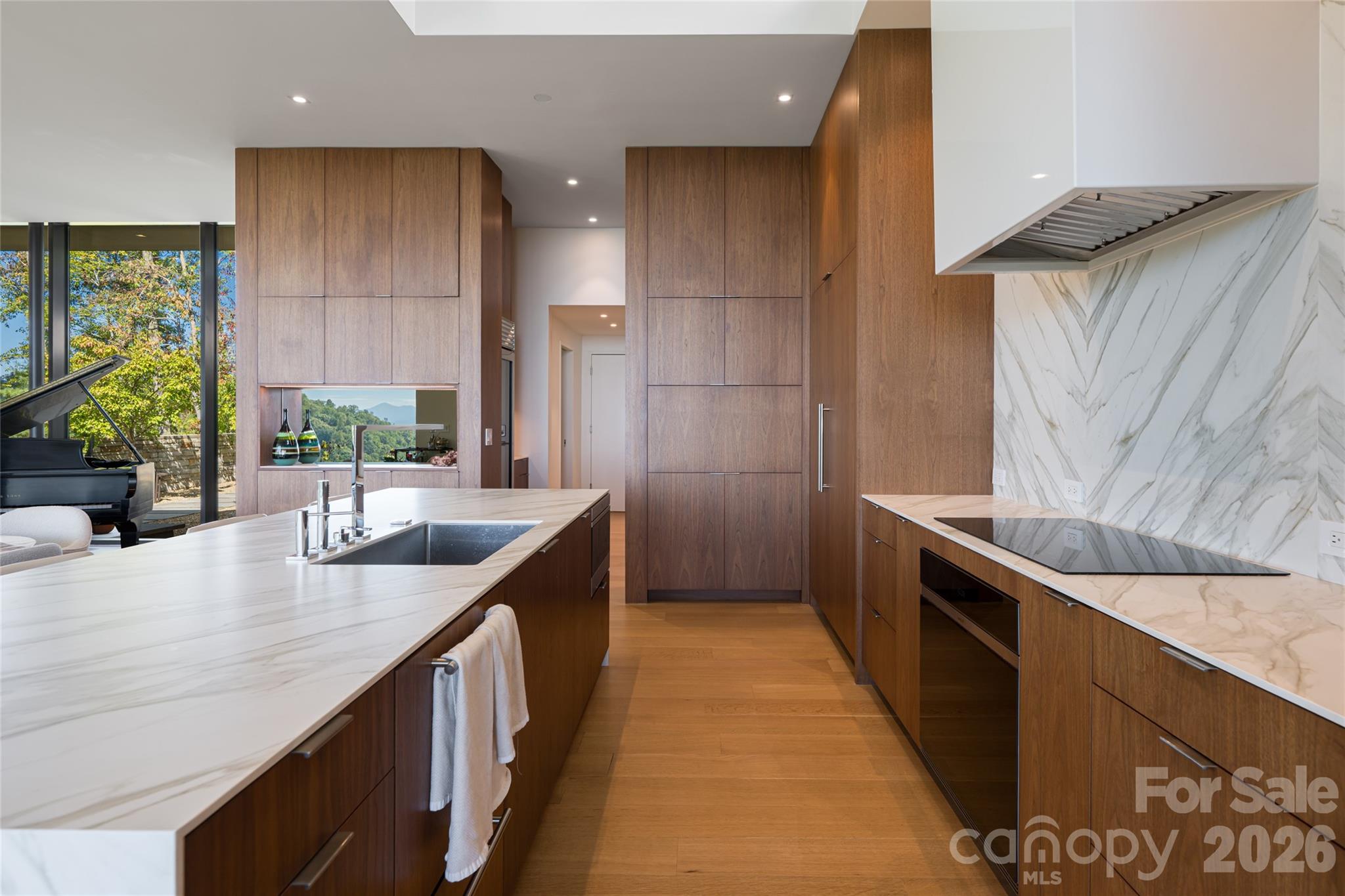 353 Retreat Ridge Way Asheville, NC 28804 - Photo 18 of 48 a kitchen with stainless steel appliances granite countertop a sink a stove and a wooden cabinets