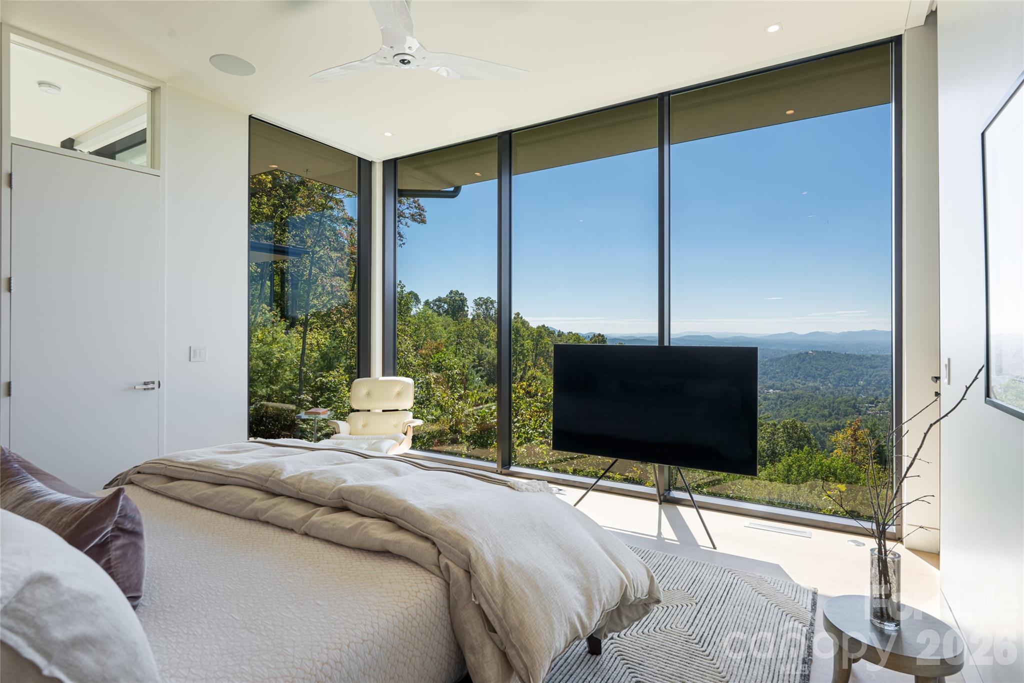 353 Retreat Ridge Way Asheville, NC 28804 - Photo 25 of 48 a bedroom with a bed television and a large window