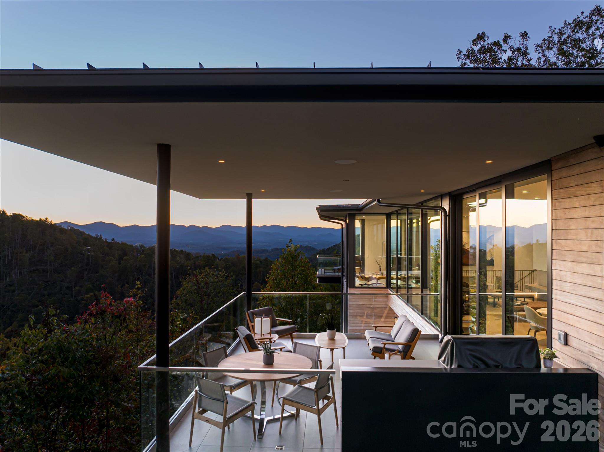 353 Retreat Ridge Way Asheville, NC 28804 - Photo 3 of 48 a view of a balcony with chairs and wooden floor