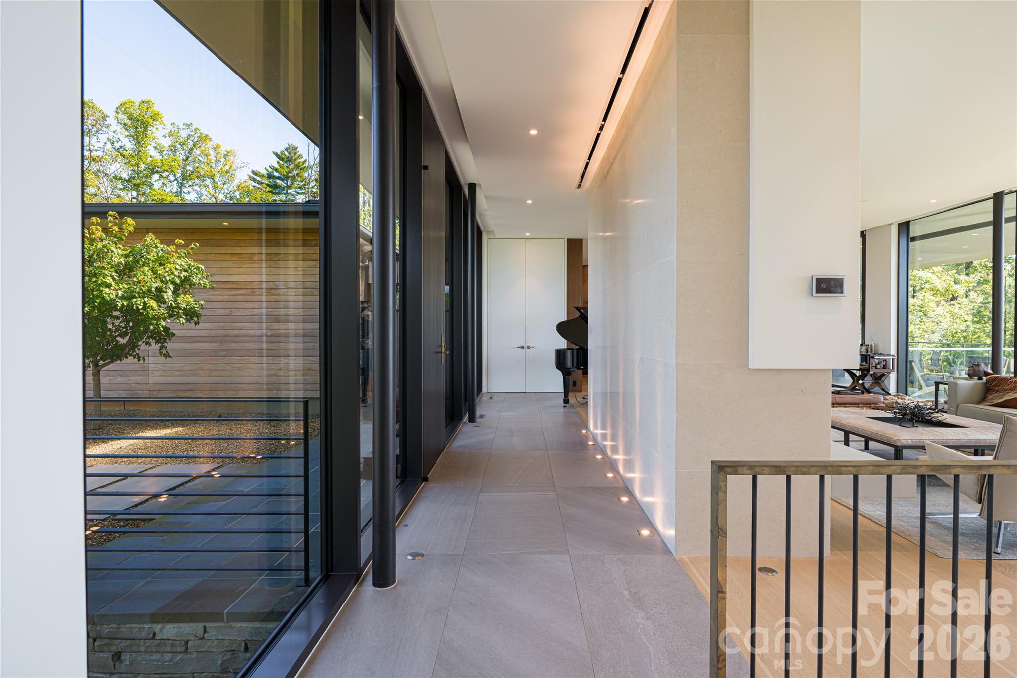 353 Retreat Ridge Way Asheville, NC 28804 - Photo 4 of 48 a view of hallway with a floor to ceiling window and wooden floor