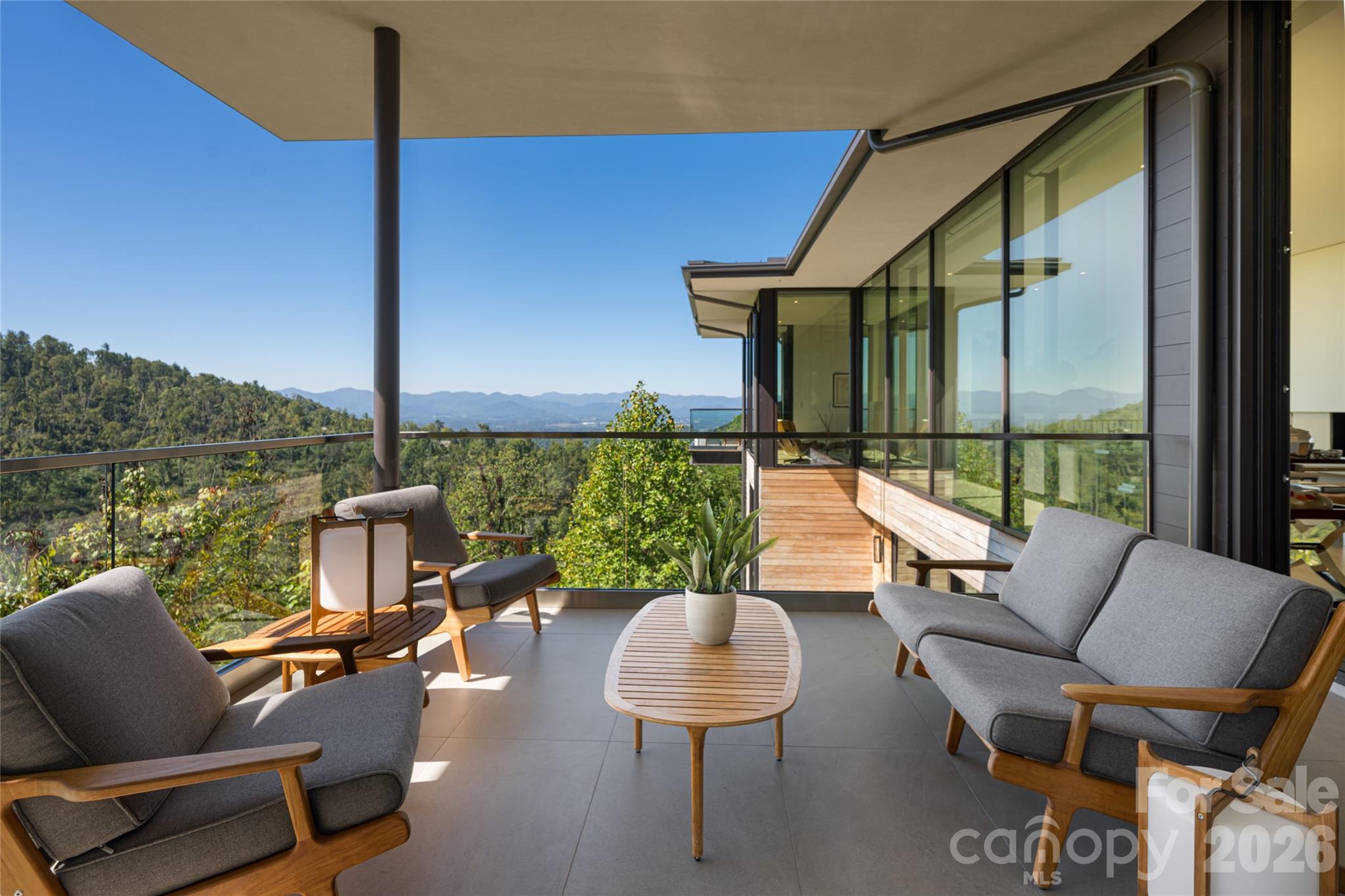 353 Retreat Ridge Way Asheville, NC 28804 - Photo 44 of 48 a balcony with furniture and a floor to ceiling window