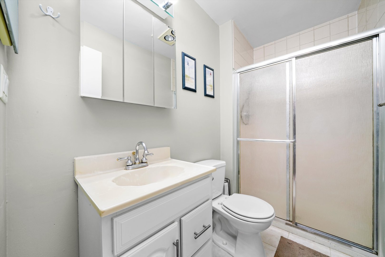 1926 Prairie Square, Unit 210B Schaumburg, IL 60173 - Photo 15 of 20 a bathroom with a sink toilet and mirror