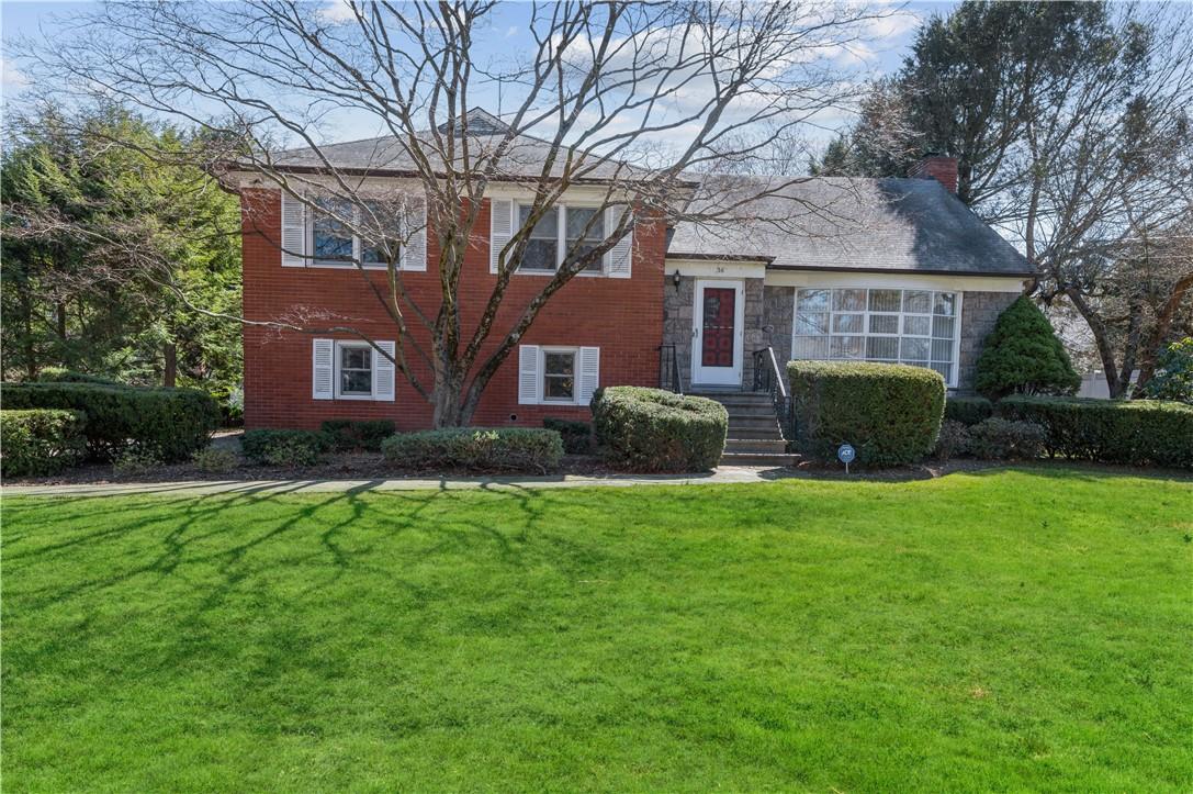 36 Windingwood Road North Rye Brook, NY 10573 - Photo 1 of 1 a front view of a house with a garden