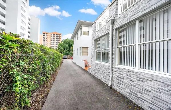 a view of a balcony with a floor to ceiling window and wooden fence