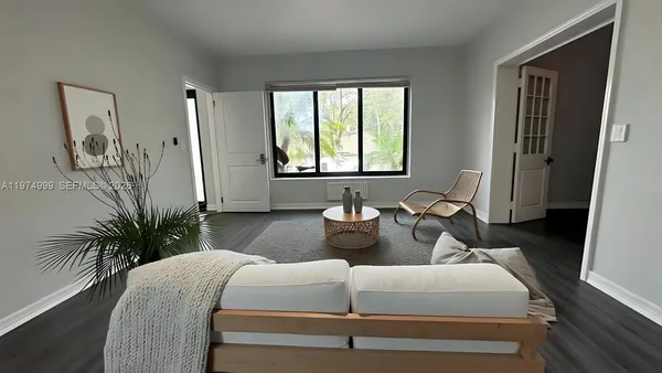 a living room with furniture and a large window