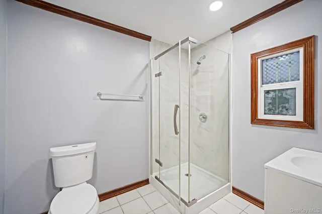 a view of a white house with a yard and garage