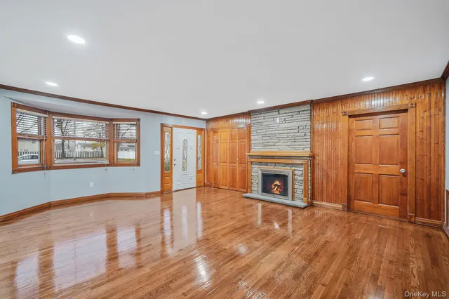 wooden floor in an empty room with a fireplace