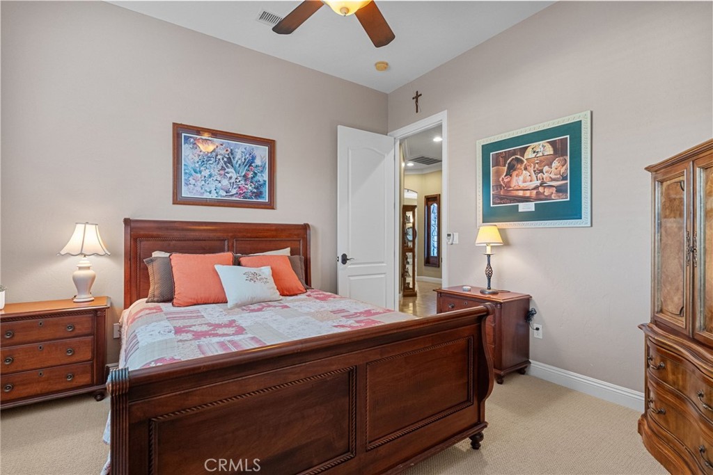 35394 Linda Rosea Road Temecula, CA 92592 - Photo 40 of 69 a bedroom with a bed and a chandelier