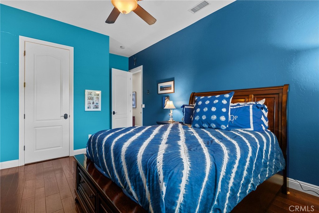 35394 Linda Rosea Road Temecula, CA 92592 - Photo 44 of 69 a bedroom with a bed and a chandelier