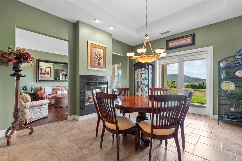 35394 Linda Rosea Road Temecula, CA 92592 - Photo 10 of 69 a dining room with furniture a chandelier and window