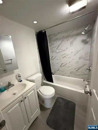 a bathroom with a sink toilet vanity and bathtub