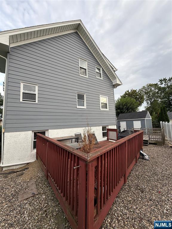61 Sabina Street, Unit 1 Little Ferry, NJ 07643 - Photo 15 of 16 a street view with wooden fence and trees