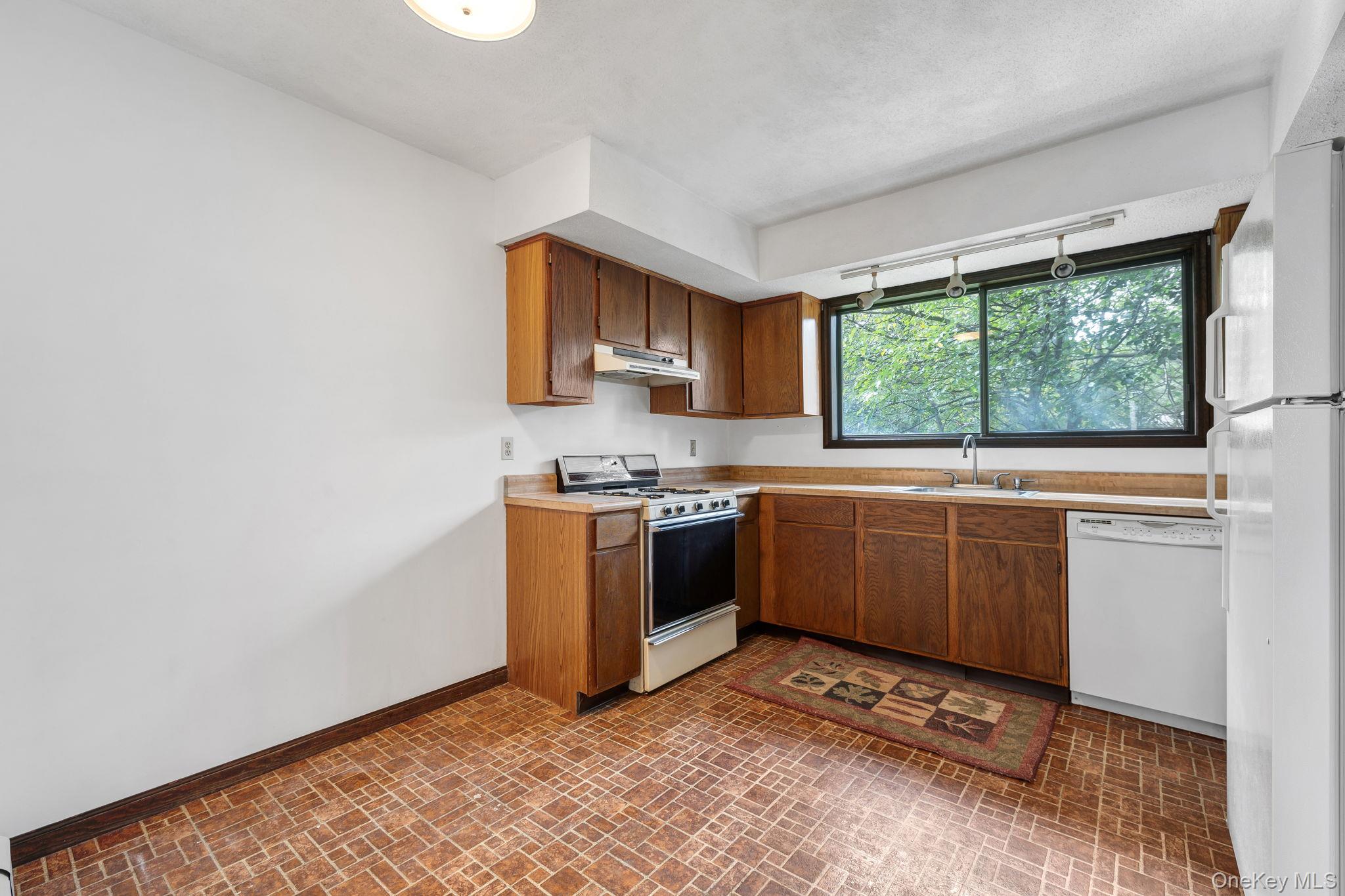9 Spruce Court Fishkill, NY 12524 - Photo 11 of 33 a kitchen with a sink cabinets and window