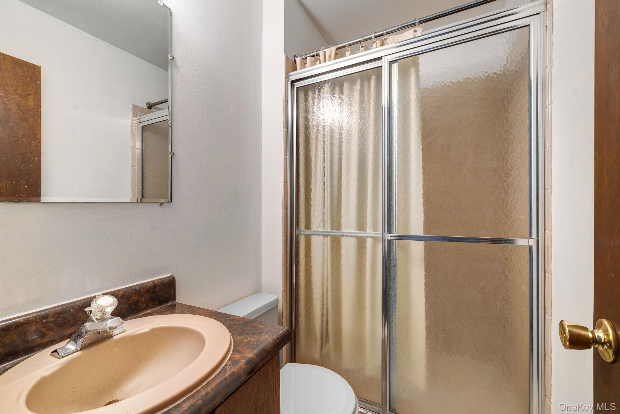 9 Spruce Court Fishkill, NY 12524 - Photo 14 of 33 a bathroom with a sink toilet and shower