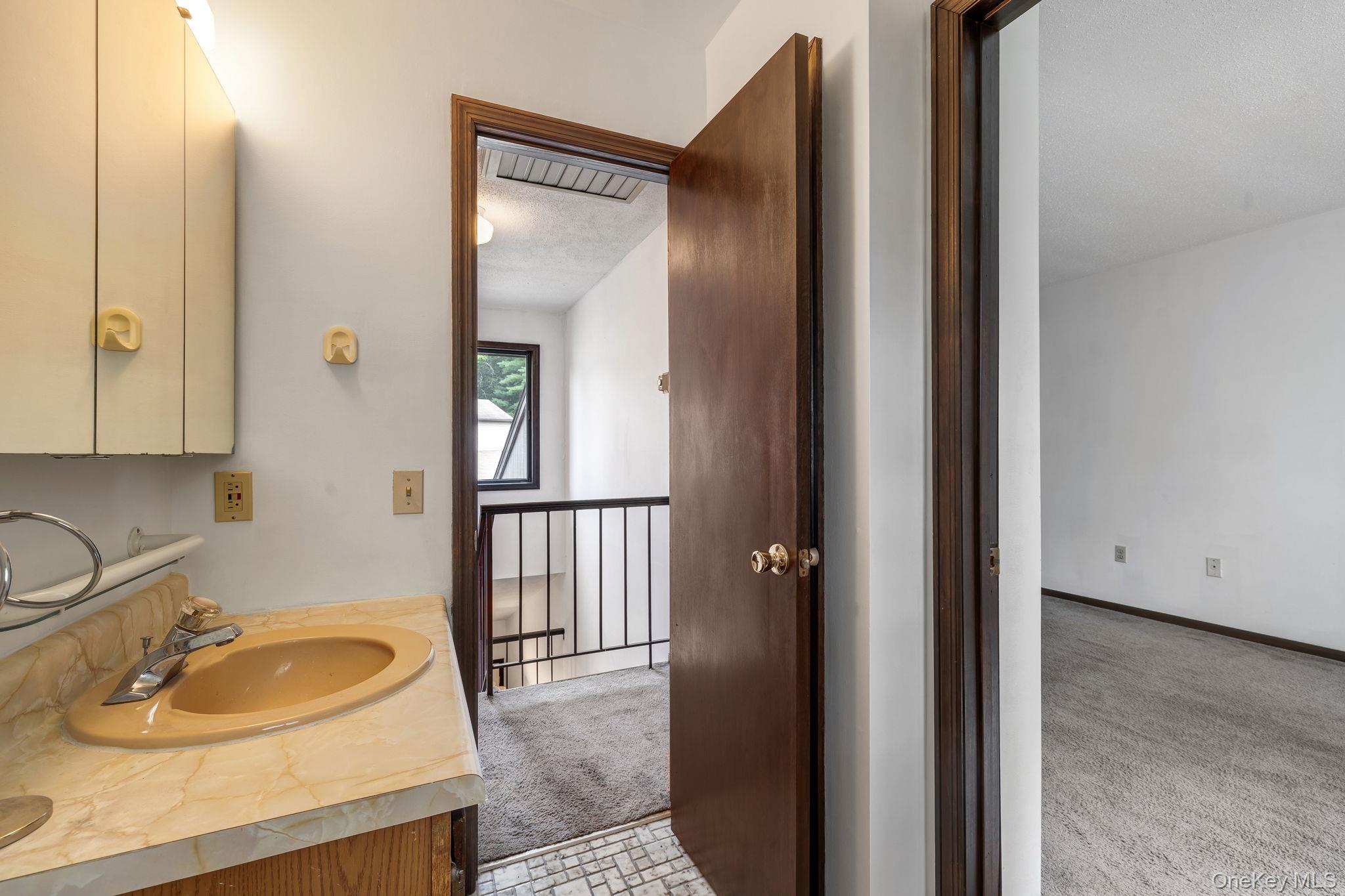 9 Spruce Court Fishkill, NY 12524 - Photo 18 of 33 a bathroom with a sink and a mirror