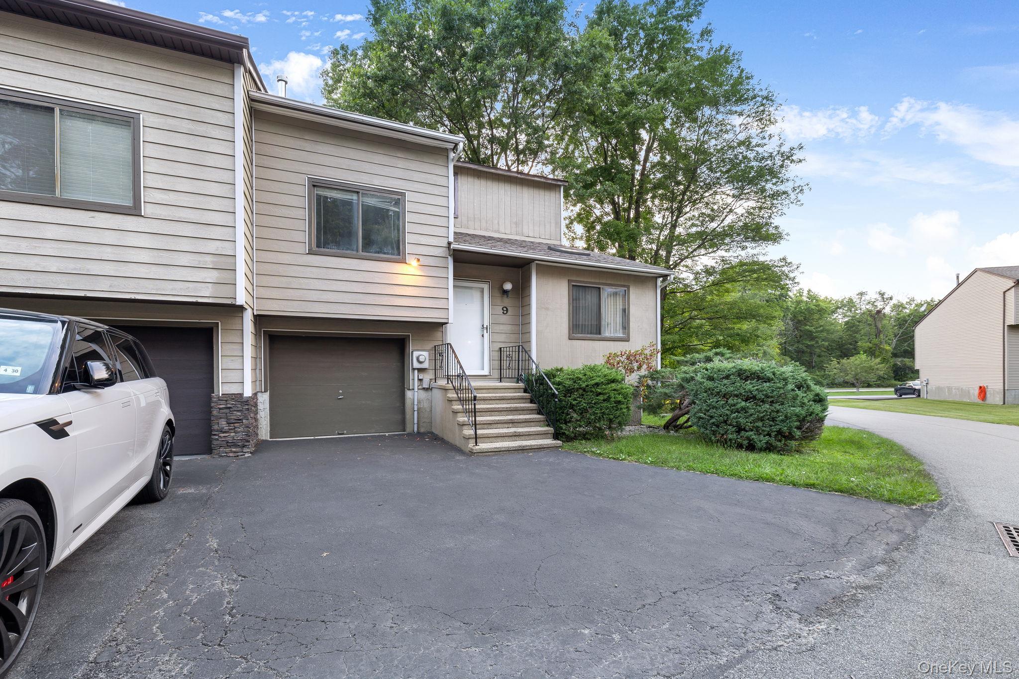 9 Spruce Court Fishkill, NY 12524 - Photo 25 of 33 a view of a house with a yard and garage