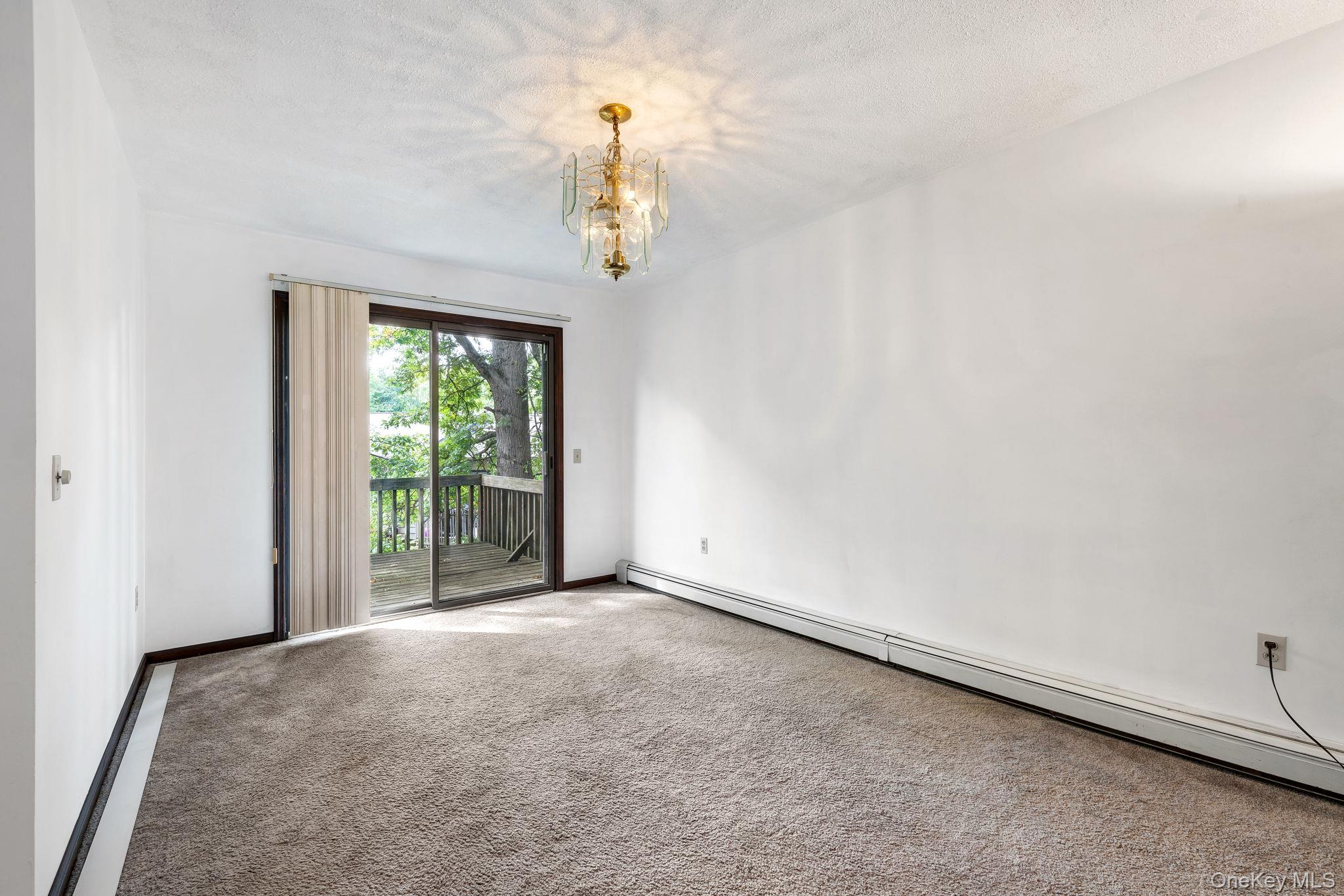 9 Spruce Court Fishkill, NY 12524 - Photo 6 of 33 wooden floor in an empty room with a window