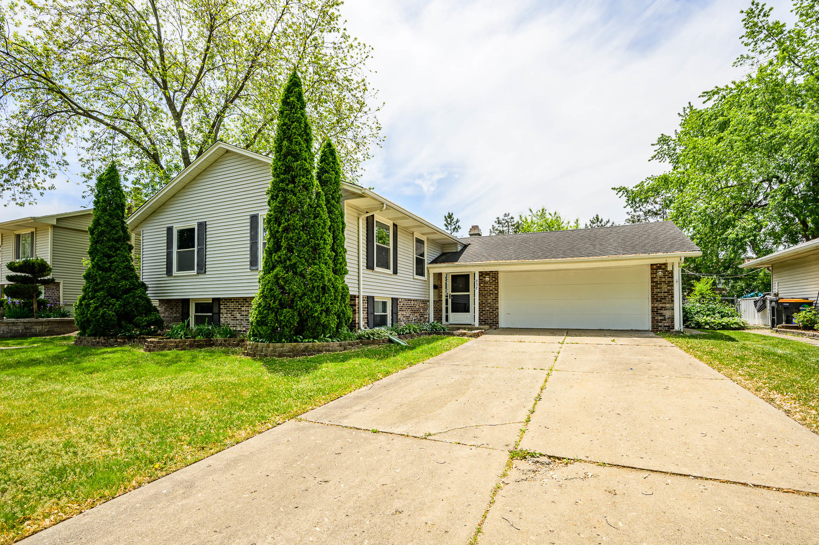 a front view of house with yard and green space