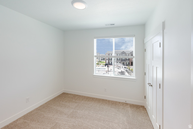 4727 South 690th West, Unit W202 Mapleton, UT 84664 - Photo 11 of 16 Neutral wall color, plush carpet, recessed lighting, window with blinds, and paneled closet doors