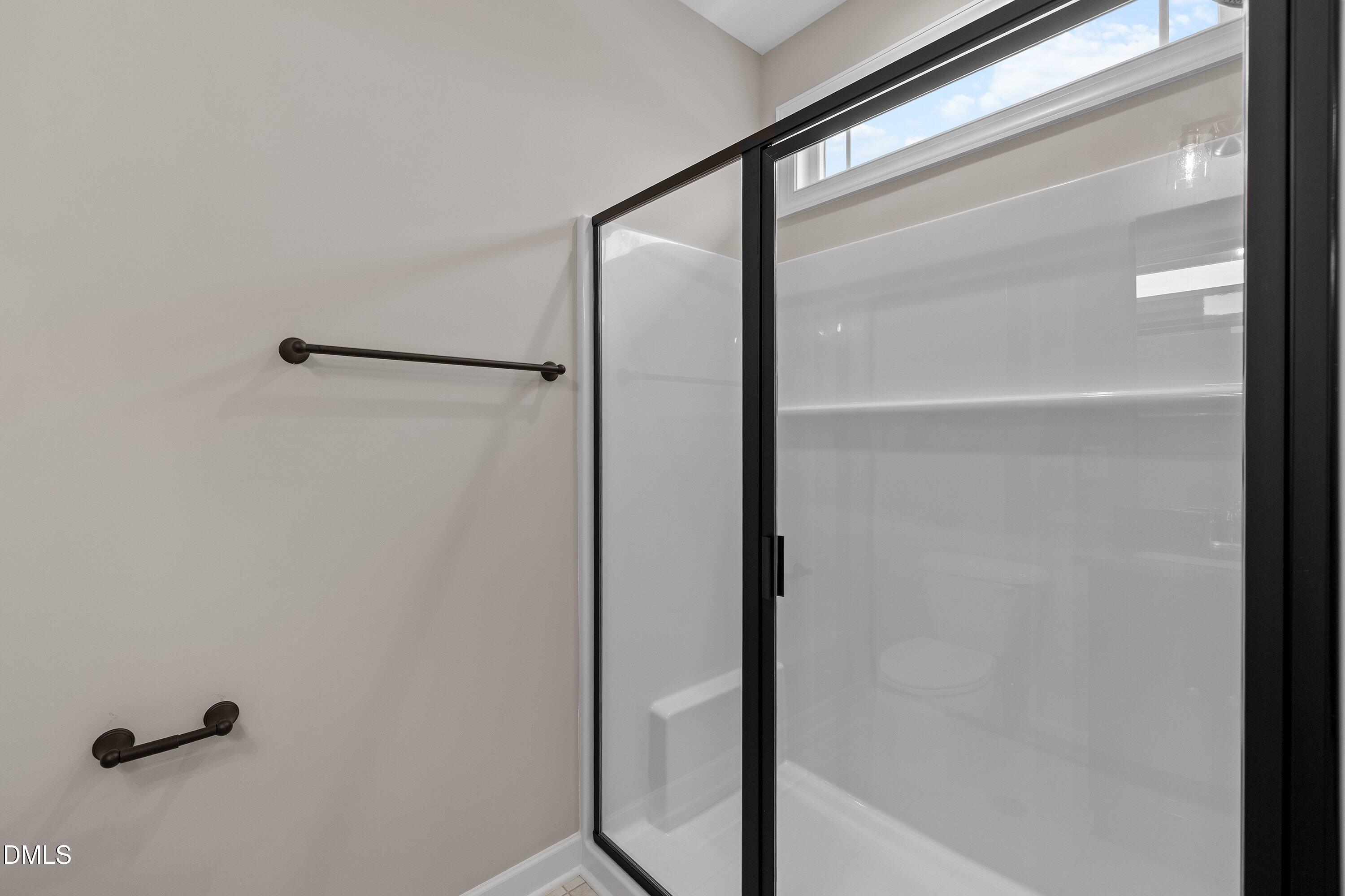 926 Micro Road West Selma, NC 27576 - Photo 36 of 41 a bathroom with a glass shower door