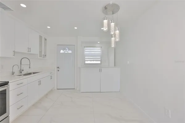 a kitchen with a sink stainless steel appliances and cabinets