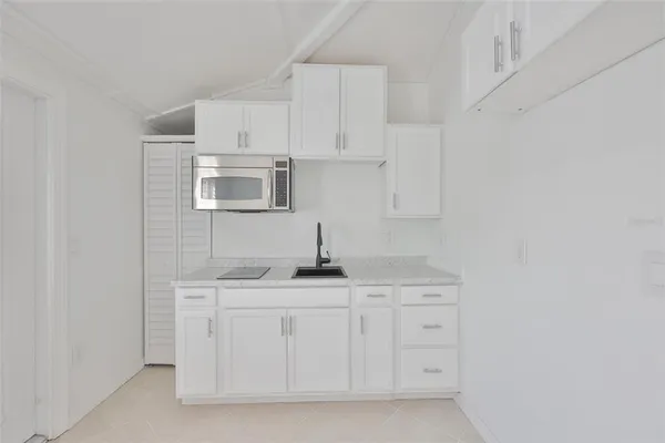 a bathroom with a toilet sink vanity and shower