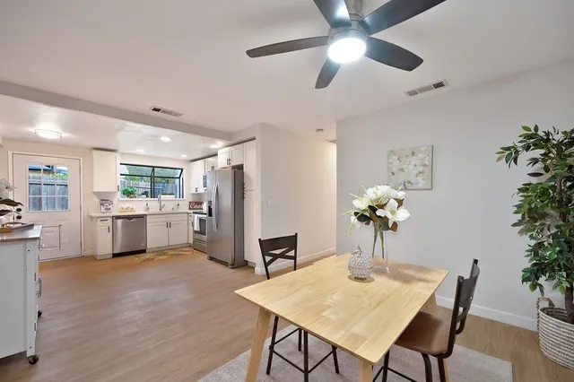 a view of a dining room with furniture and a kitchen