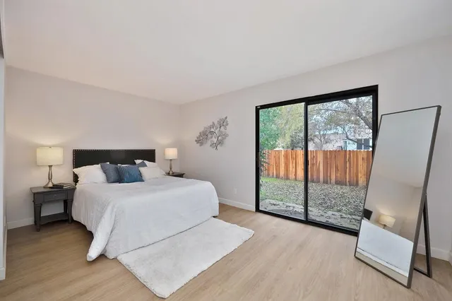 a bedroom with a large bed and a large window