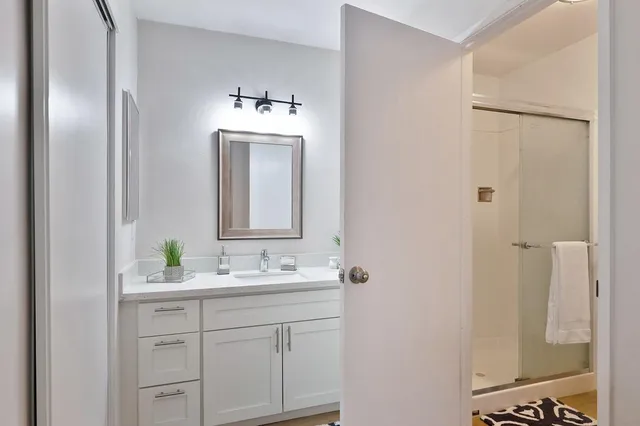a bathroom with a sink vanity and mirror