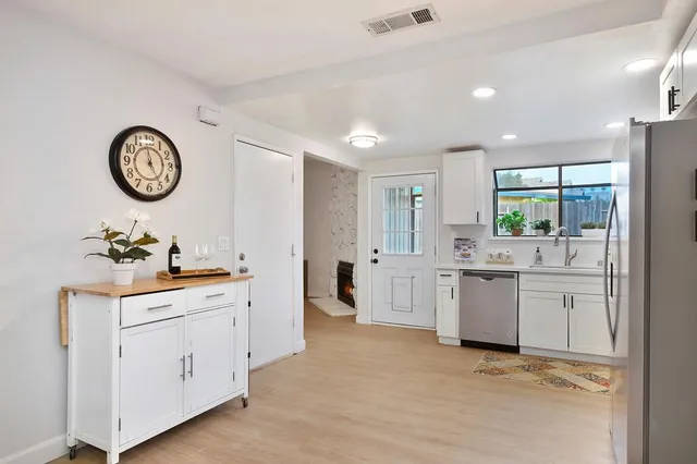 a kitchen with cabinets and window