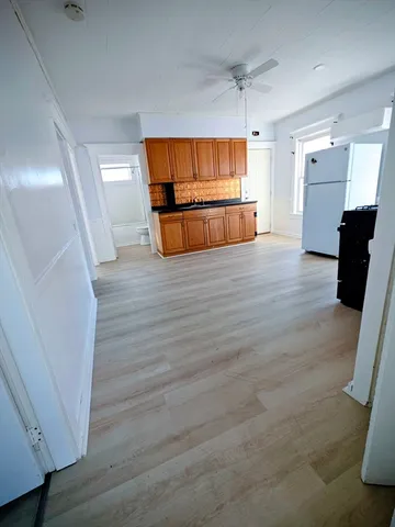 a view of a kitchen with a sink and a refrigerator