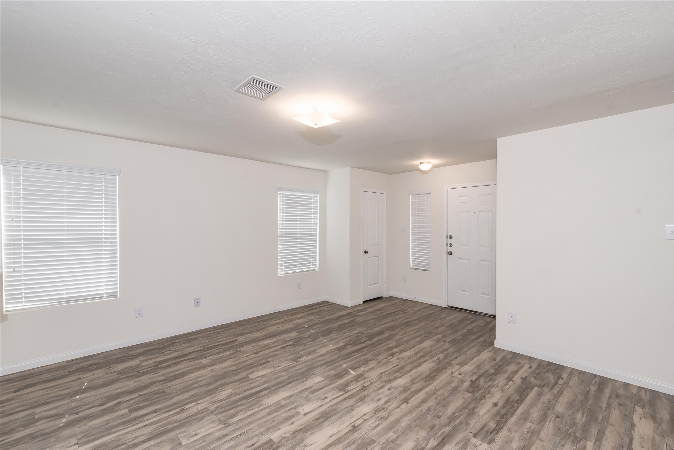 5312 Rio Ramos Street Rosharon, TX 77583 - Photo 7 of 11 a view of an empty room with wooden floor and a window