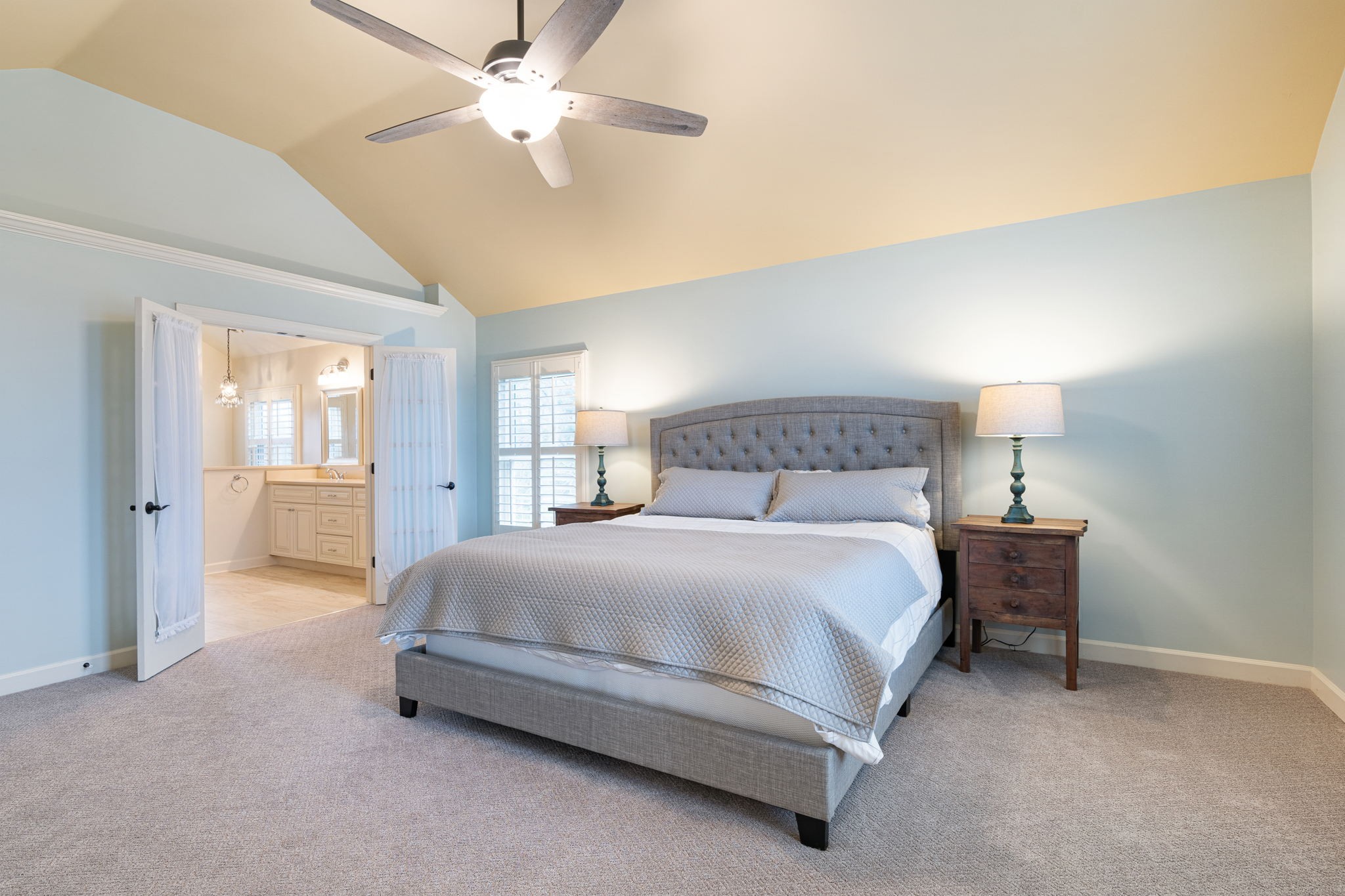 910 Riverbend Road Nashville, TN 37221 - Photo 21 of 48 a spacious bedroom with a bed and a chandelier