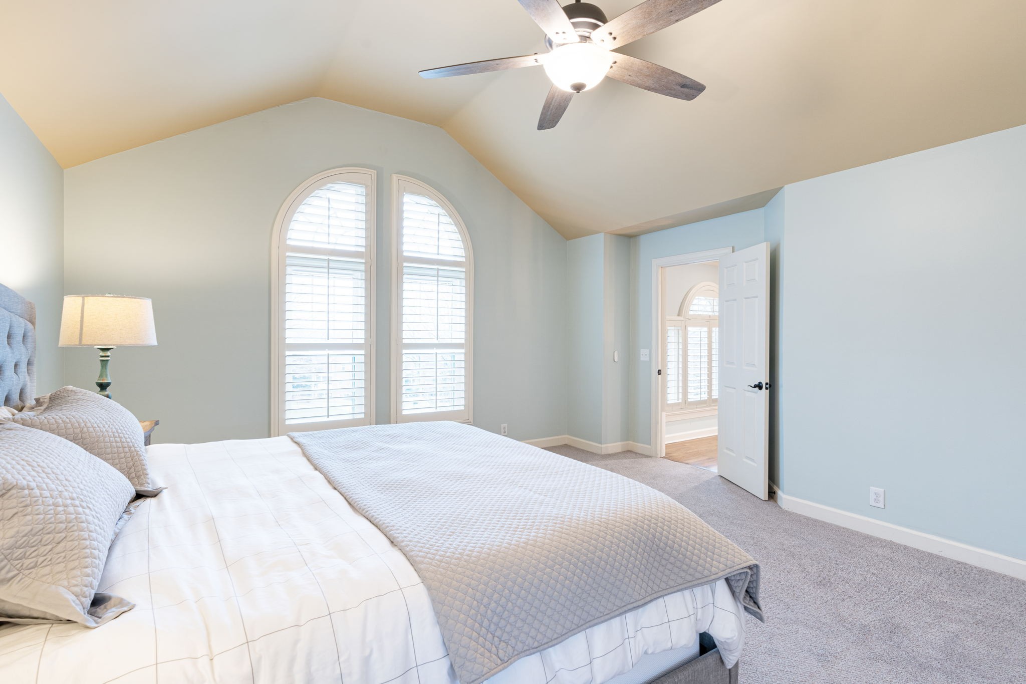 910 Riverbend Road Nashville, TN 37221 - Photo 22 of 48 a bedroom with a large bed and a chandelier