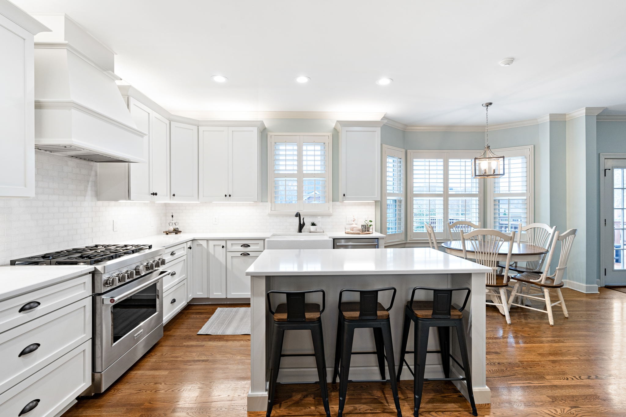 910 Riverbend Road Nashville, TN 37221 - Photo 5 of 48 a kitchen with stainless steel appliances granite countertop a stove top oven a sink dishwasher and white cabinets with wooden floor