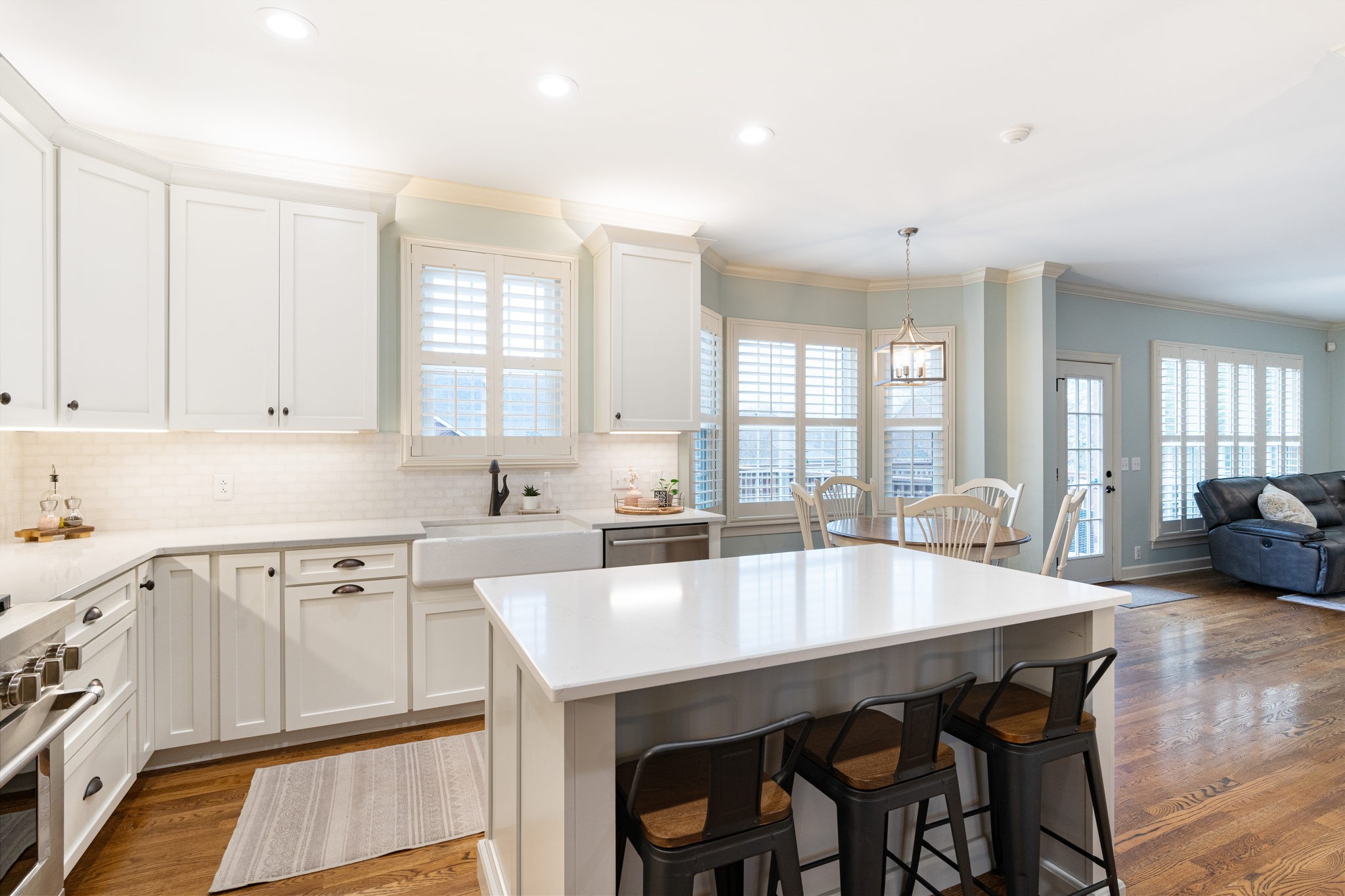 910 Riverbend Road Nashville, TN 37221 - Photo 7 of 48 a kitchen with a dining table chairs and white cabinets