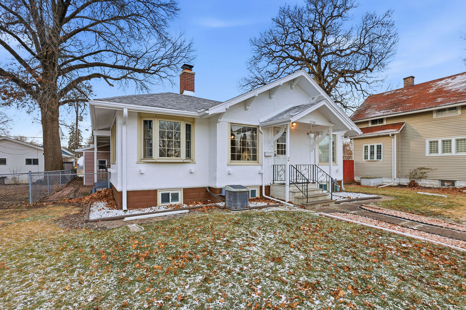 2748 12th Avenue Moline, IL 61265 - Photo 35 of 35 a front view of a house with a yard and many windows