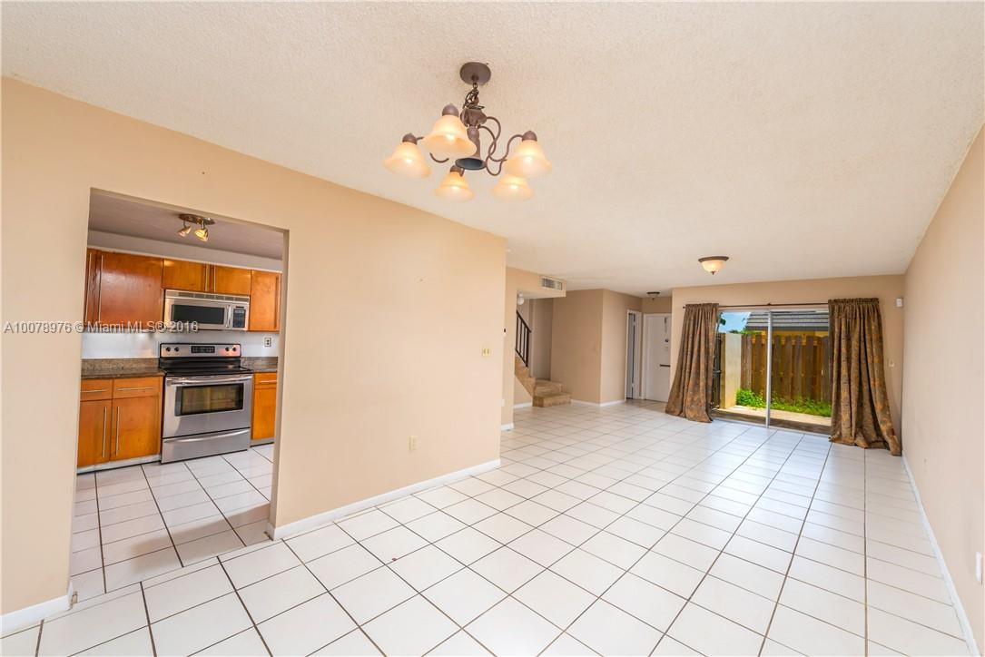 8375 Southwest 137th Avenue, Unit 8375 Miami, FL 33183 - Photo 18 of 30 a view of a kitchen with furniture an empty room and kitchen view