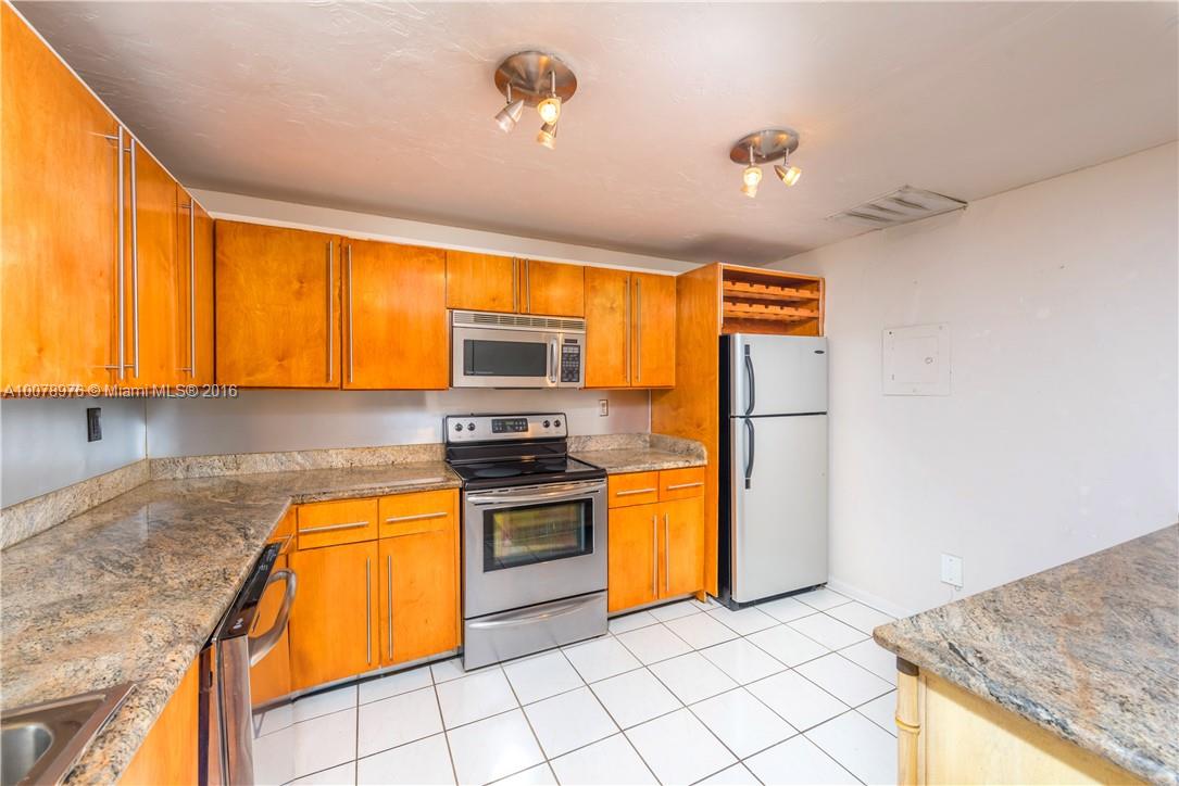 8375 Southwest 137th Avenue, Unit 8375 Miami, FL 33183 - Photo 19 of 30 a kitchen with stainless steel appliances granite countertop a sink dishwasher stove and refrigerator