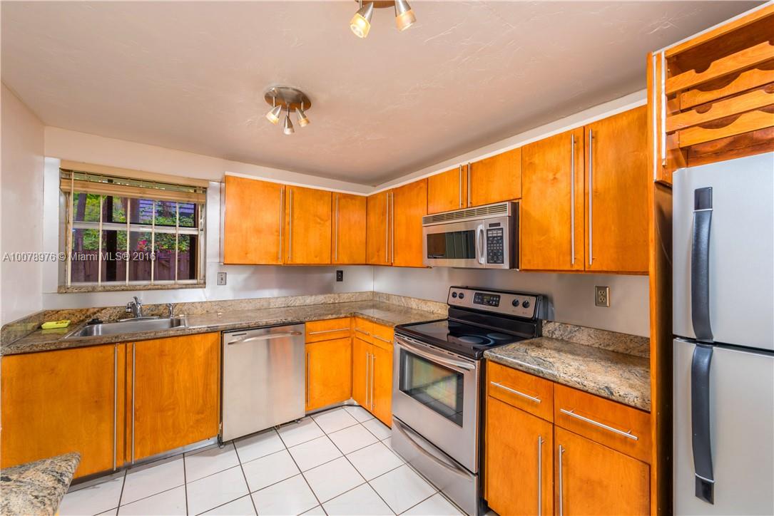 8375 Southwest 137th Avenue, Unit 8375 Miami, FL 33183 - Photo 20 of 30 a kitchen with granite countertop a sink stainless steel appliances and cabinets
