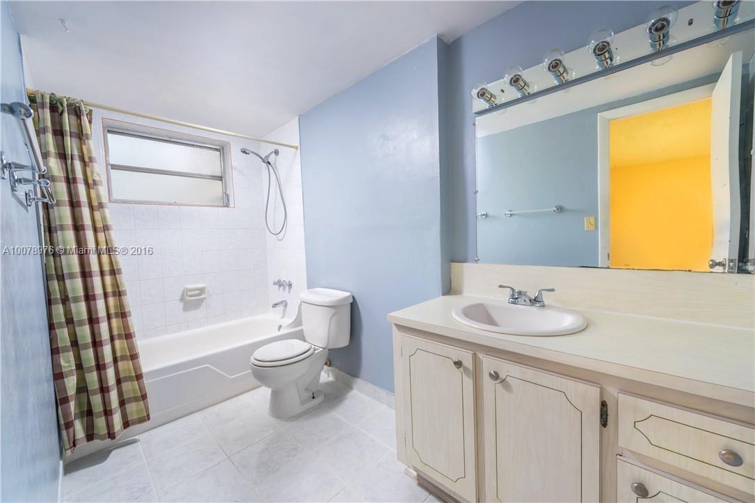 8375 Southwest 137th Avenue, Unit 8375 Miami, FL 33183 - Photo 23 of 30 a bathroom with a sink a toilet and shower