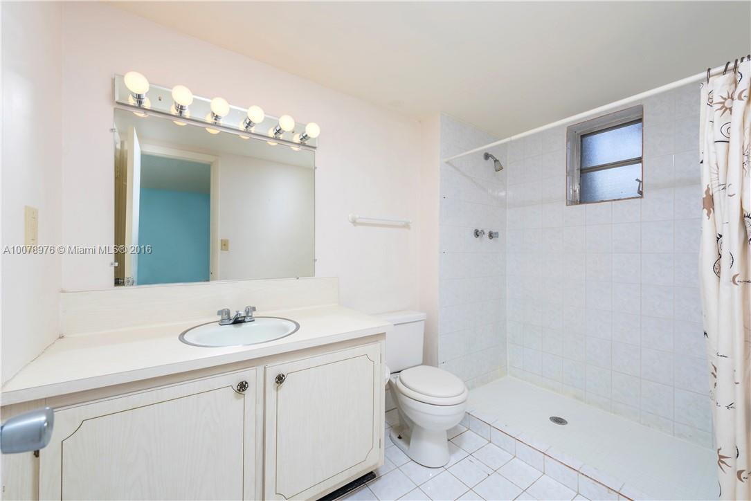 8375 Southwest 137th Avenue, Unit 8375 Miami, FL 33183 - Photo 27 of 30 a bathroom with a sink a toilet and shower